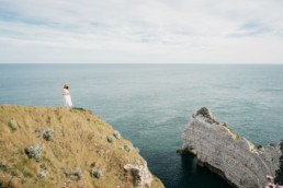 Girl standing next to a cliff in Etretat