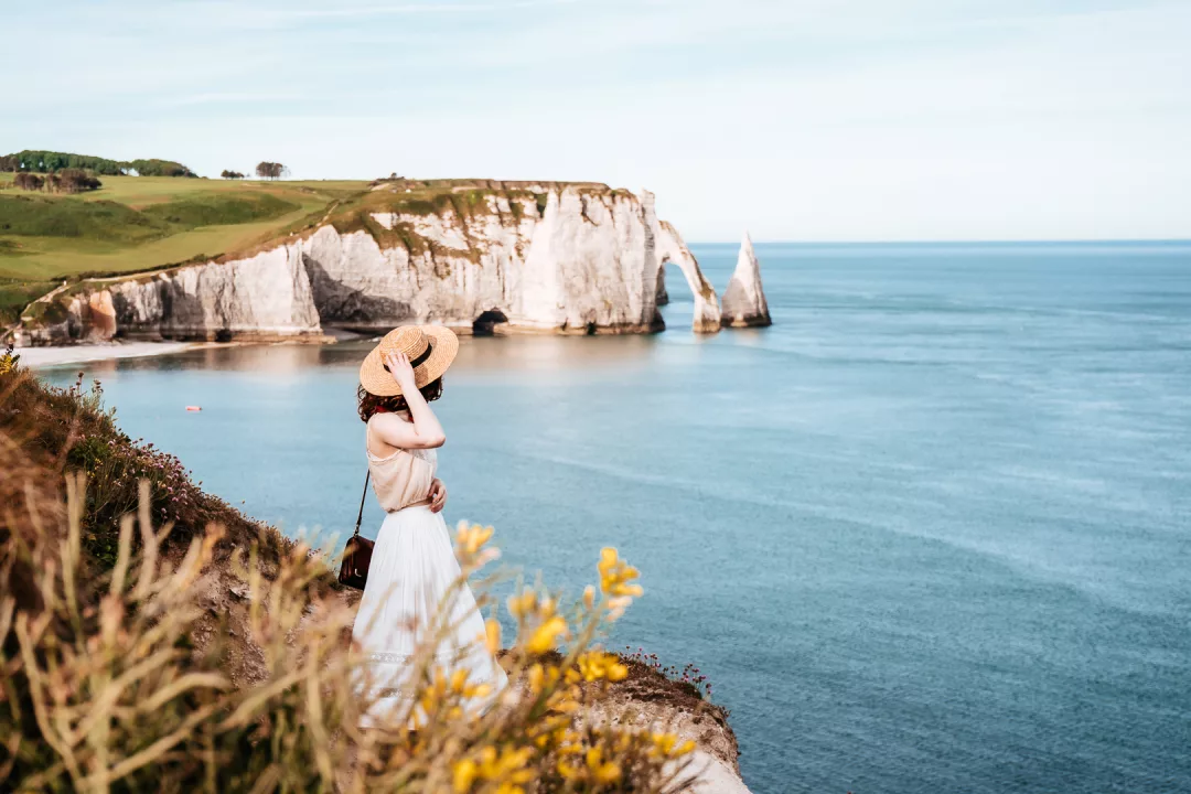 woman looking at the cliffs of etretat