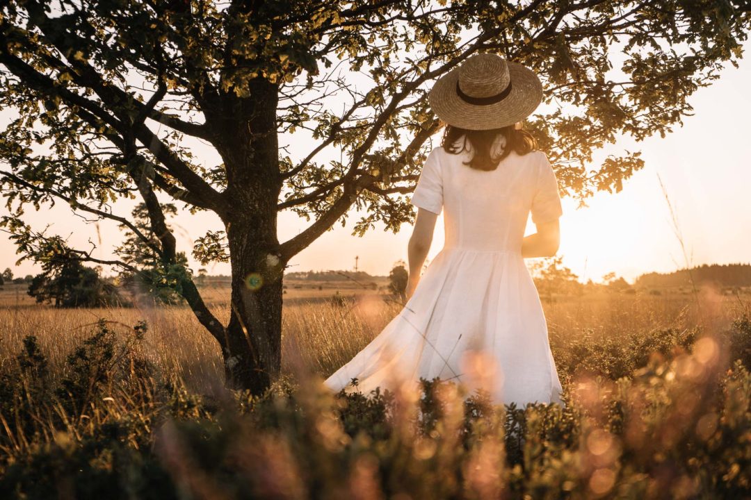 Girl in a dress during an August sunrise