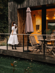 Girl in a dress in front of a passive eco-house