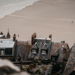 Tide coming in behind the houses of Mont Saint-Michel