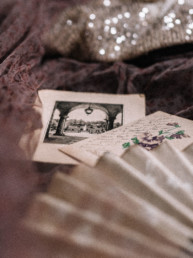 Antique fan, old postcards and a madame shoushou dress thrown together