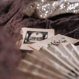 Antique fan, old postcards and a madame shoushou dress thrown together