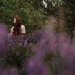 Woman sitting in a field of heather