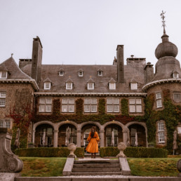 woman standing in front of manoir de lebioles castle