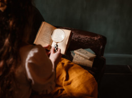 woman holding a vintage magnifier over a book