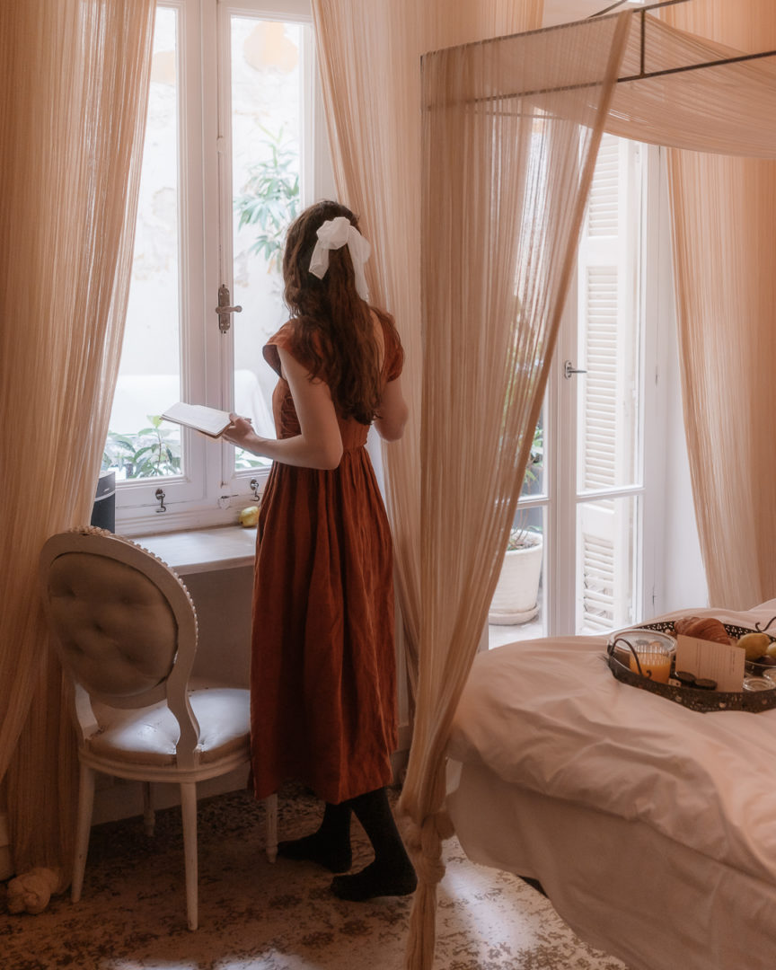 woman looking out the window at shila athens hotel