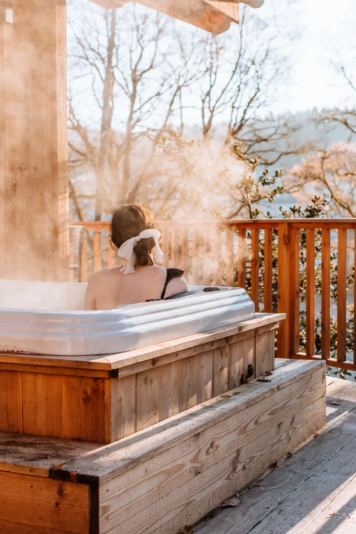 woman in a jacuzzi on a cabin terrace