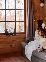 woman relaxing in a cozy cabin in the woods