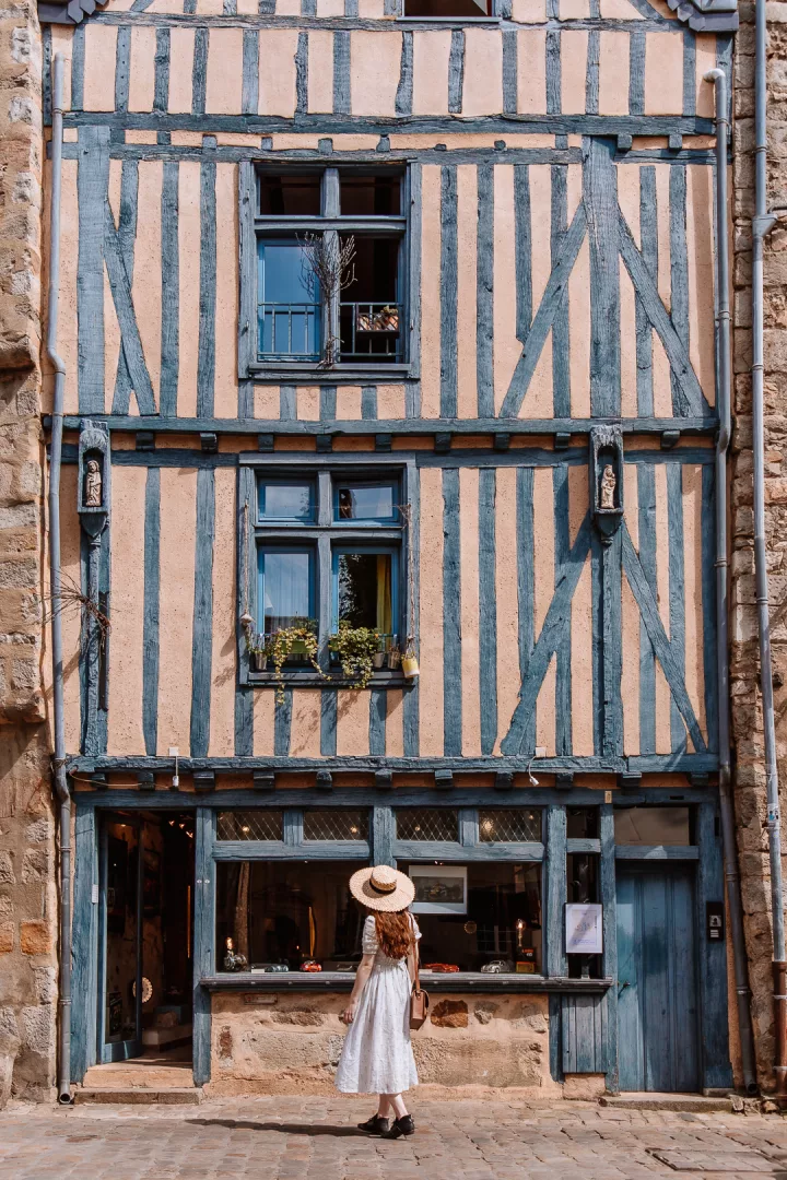 woman in front of a half-timbered house in le mans