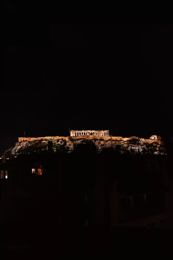 view of the acropolis at night from mona athens hotel
