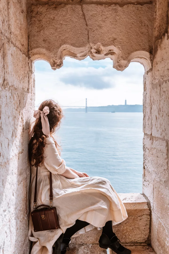woman enjoying the view from belem tower in lisbon