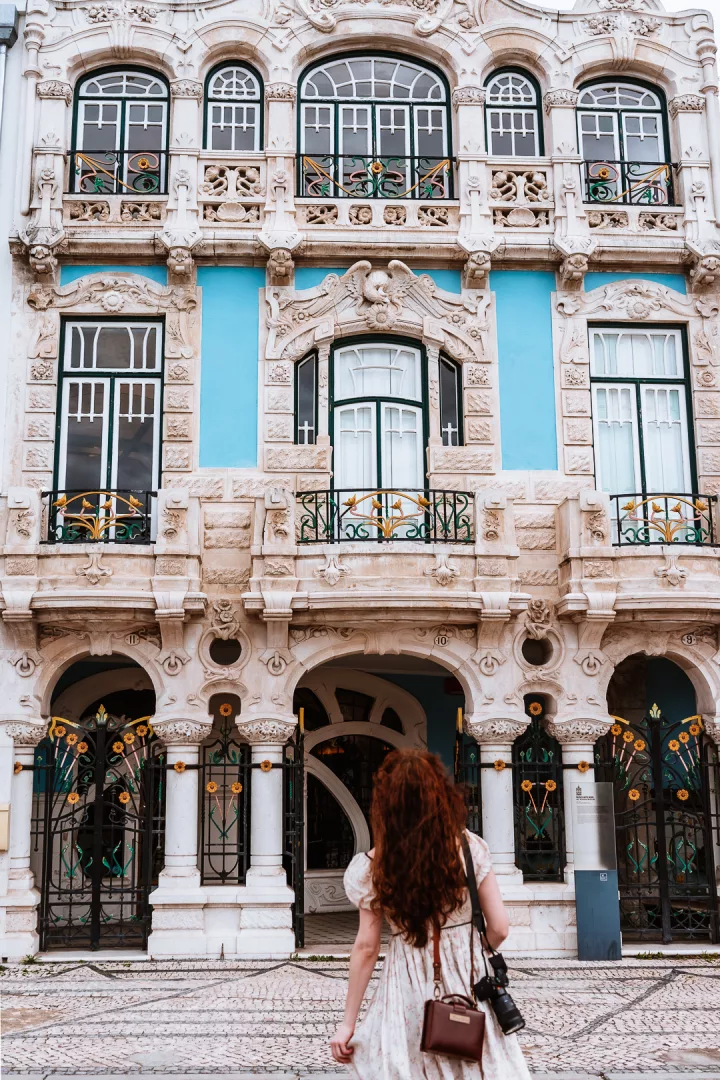 woman in front of an art nouveau building in aveiro