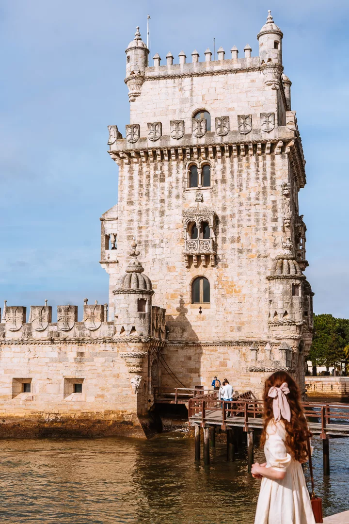 woman in front of belem tower in lisbon