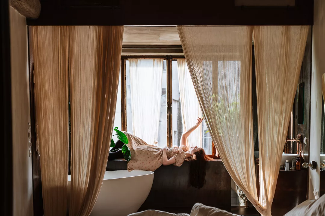 woman relaxing in a room at mona athens hotel