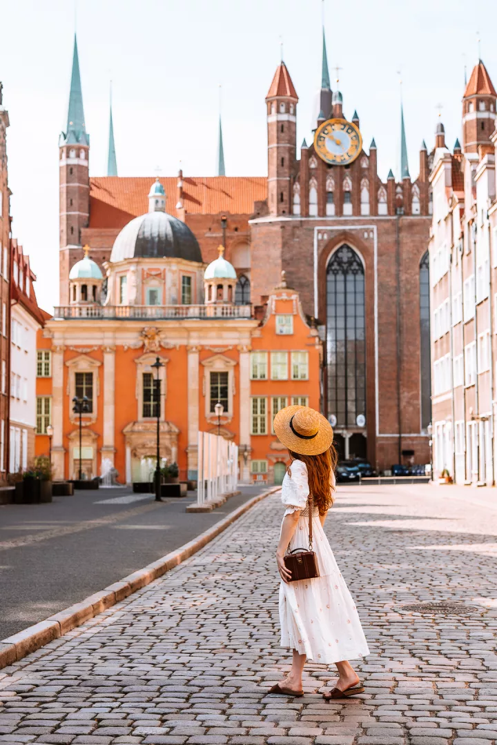 woman walking in front of royal chapel in gdansk