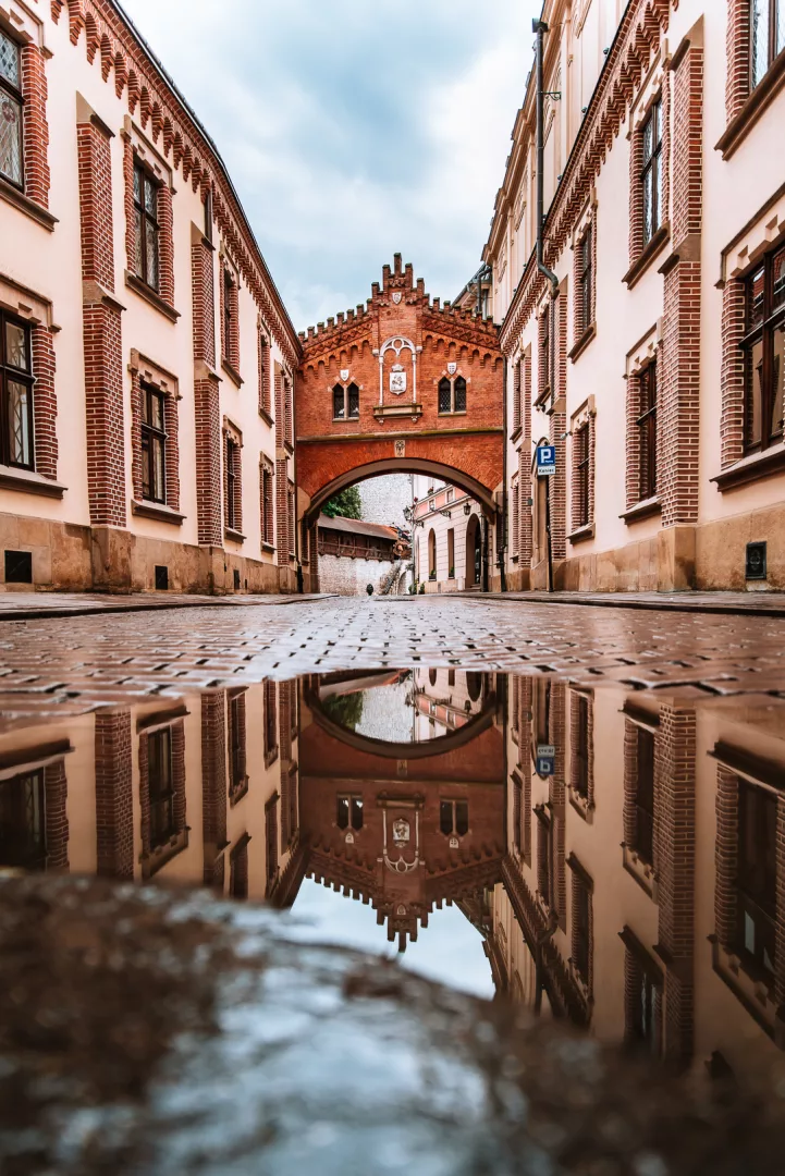 street arch in krakow reflection