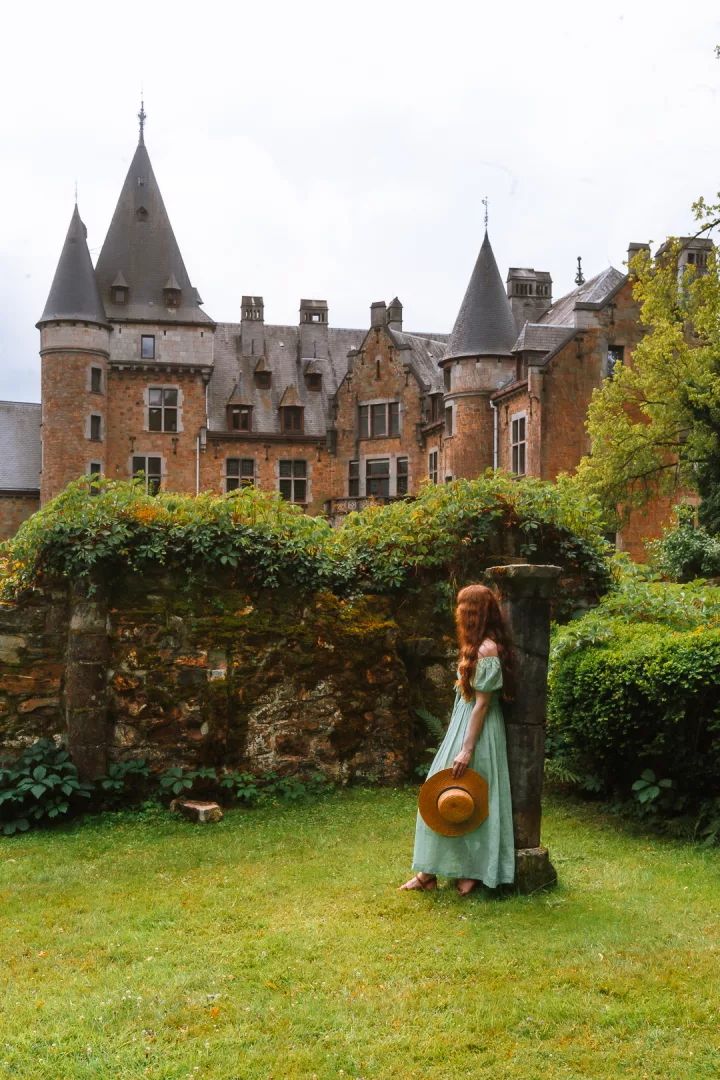 woman leaning on castle ruins at chateau de froidcour