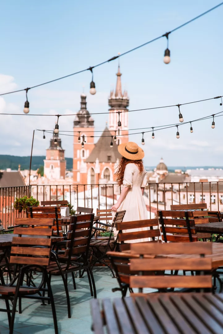 woman overlooking krakow from a rooftop bar