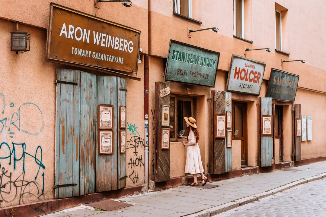 woman peeking into an old restaurant in krakow